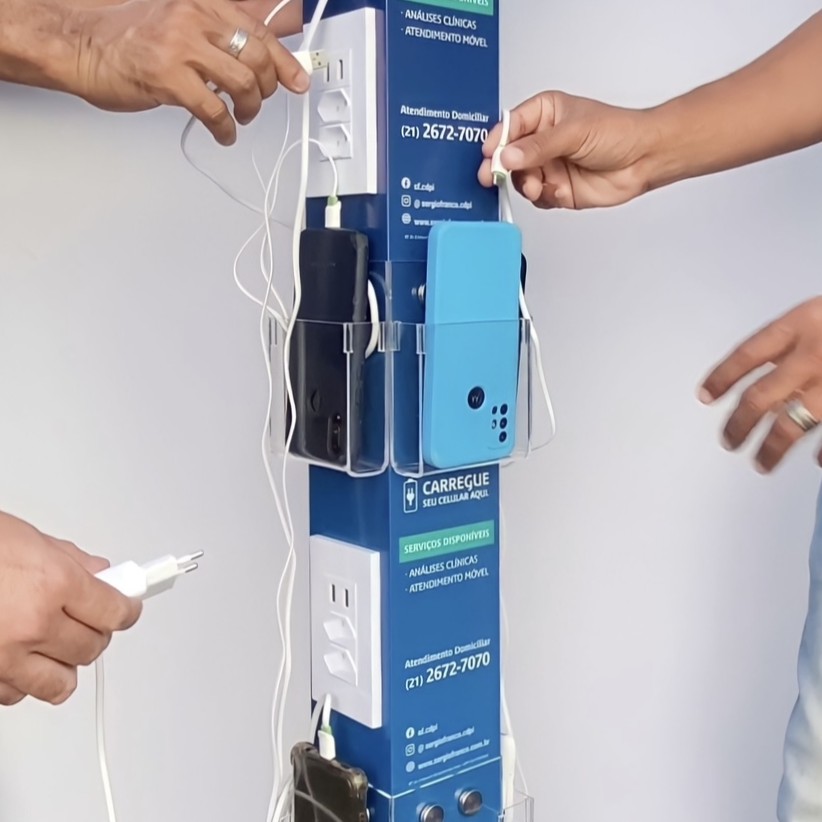 Totem de Torre com 22 pontos de recarga personalizado, três pessoas carregando celulares ao mesmo tempo
